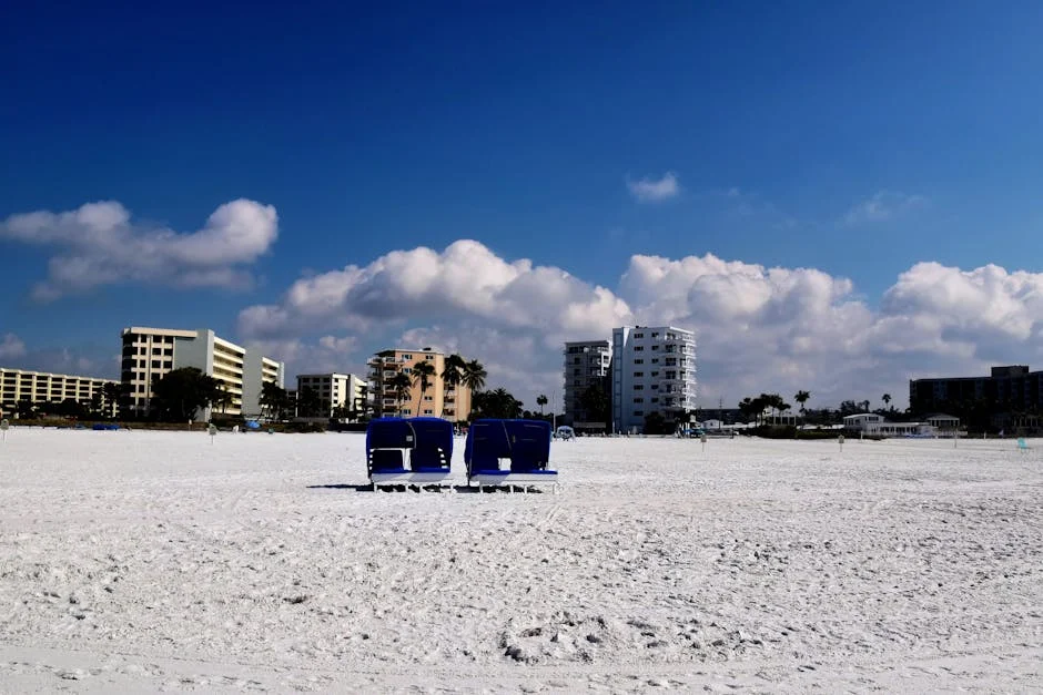 "Luxurious beachfront condo complex with palm trees, highlighted in 'Top 10 Best Beach Condos to Buy in 2025'."